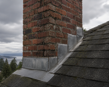 brick chimney meeting a shingle roof
